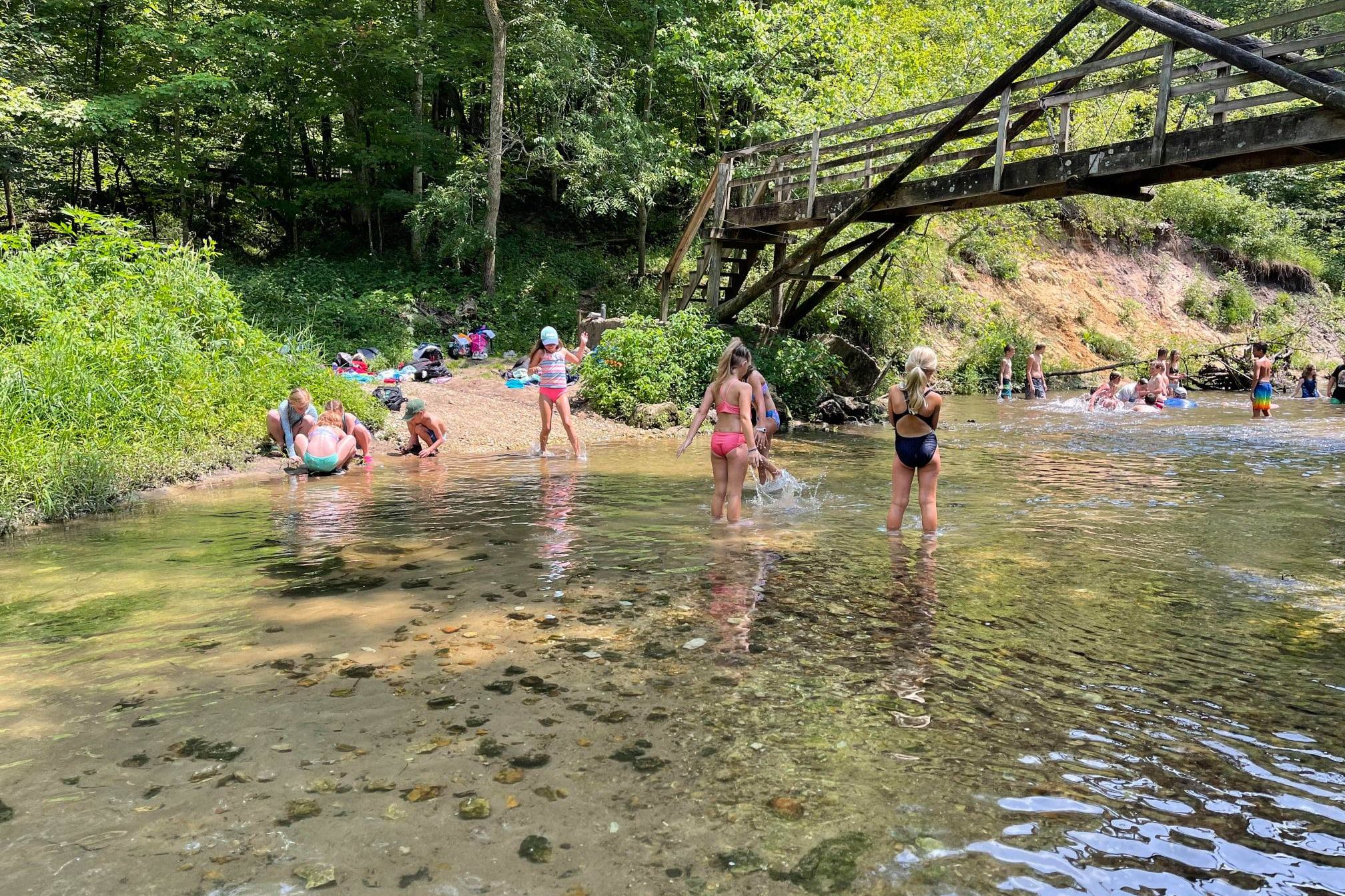 Summer camp A-frame bridge Campers playing in the river underneath the A-Frame Bridge.