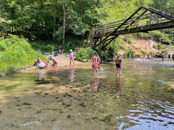 Summer camp A-frame bridge Campers playing in the river underneath the A-Frame Bridge.