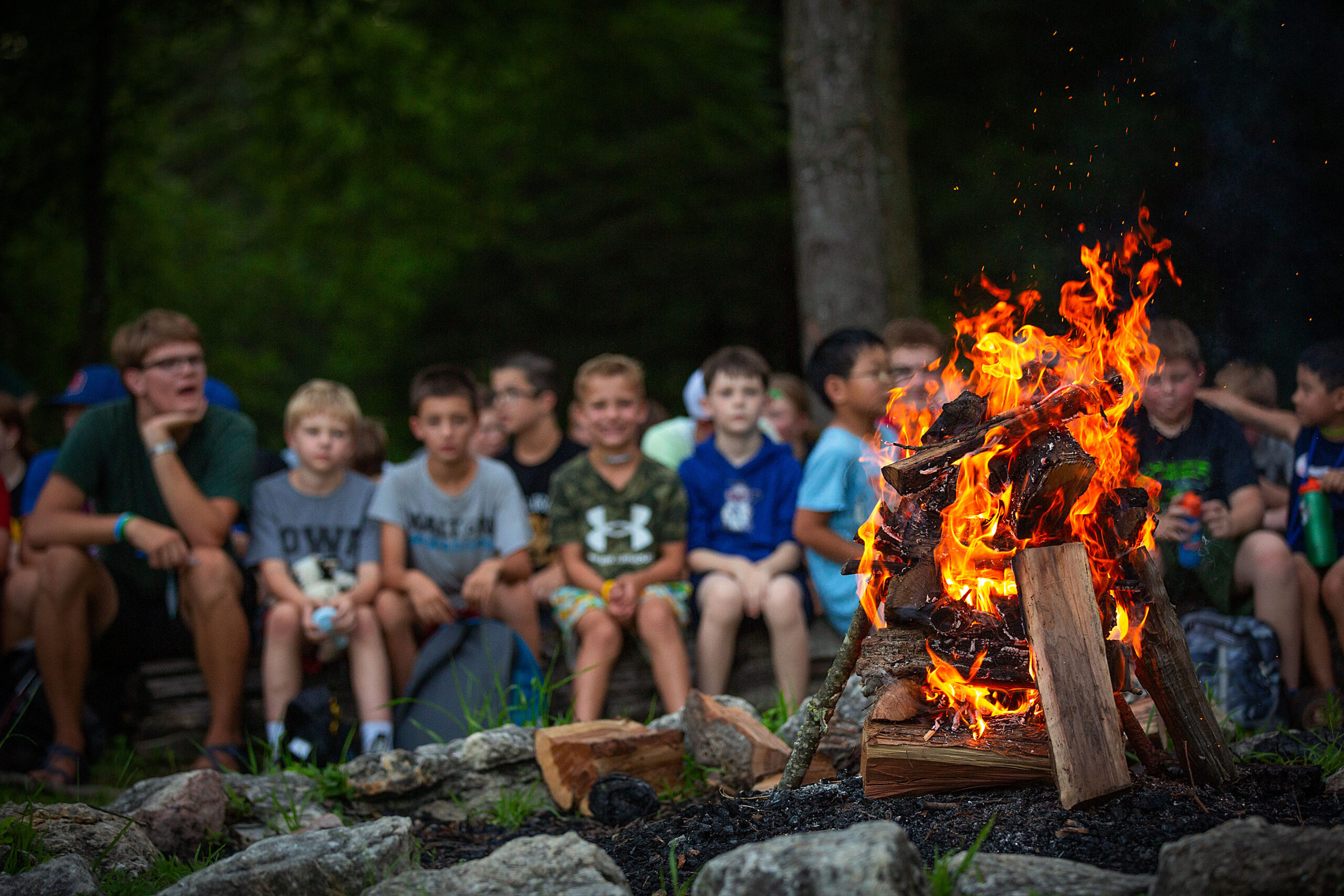 Campers sitting around a campfire