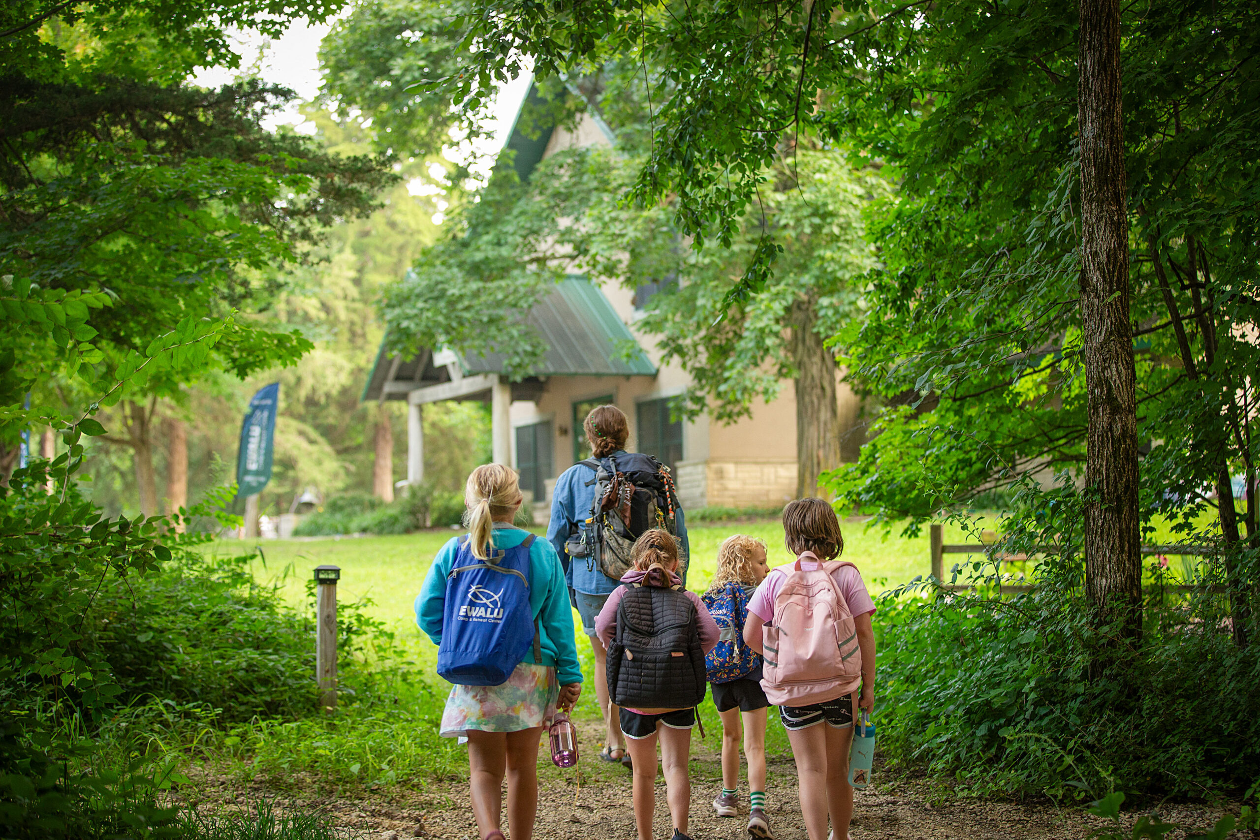 Campers and a counselor walking in the woods